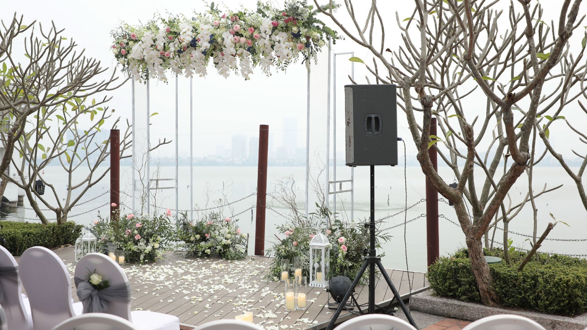 A Table With A Speaker And Flowers On It